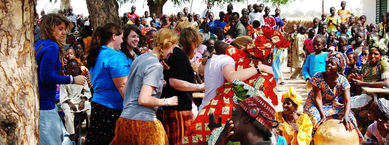 students learning African dance with villagers while on mission trip