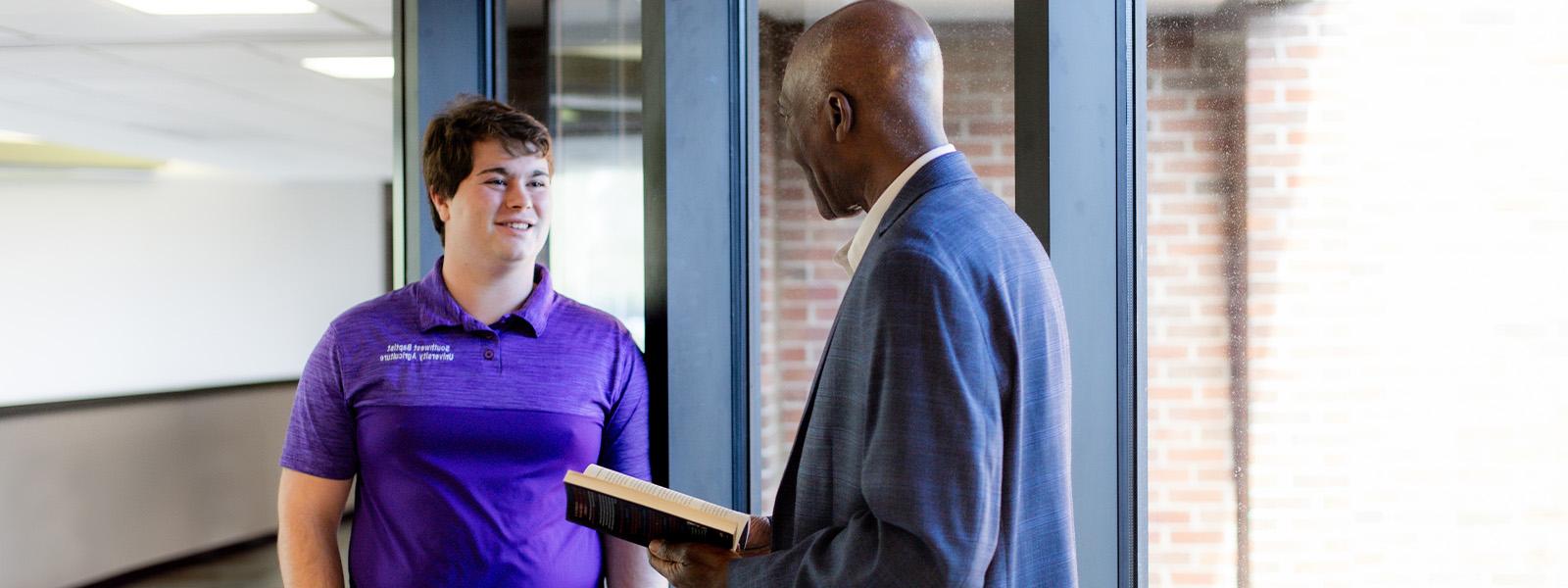 student giving presentation next to map on computer screen