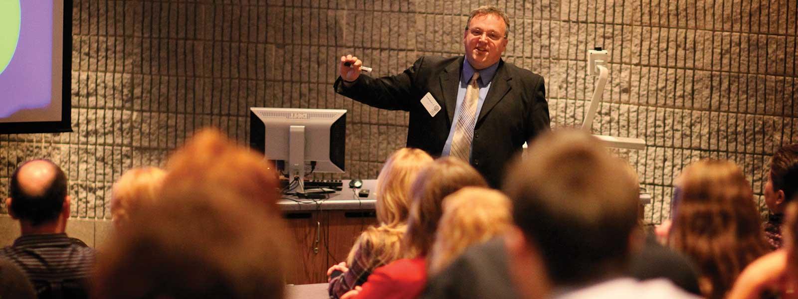 history professor giving lecture in auditorium